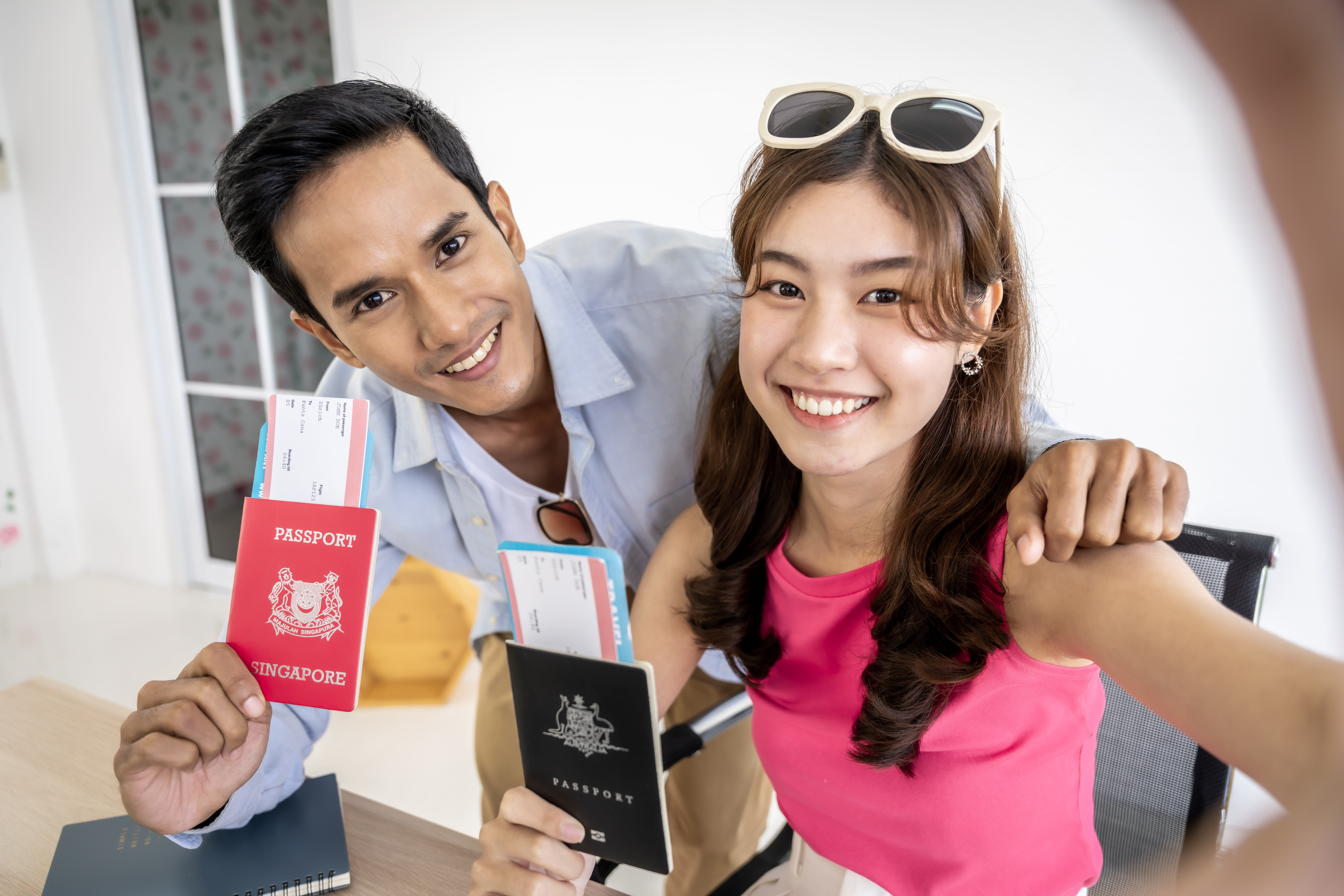Entrepreneurs holding their passports ready to come into the United States to work after receiving their employment visas.
