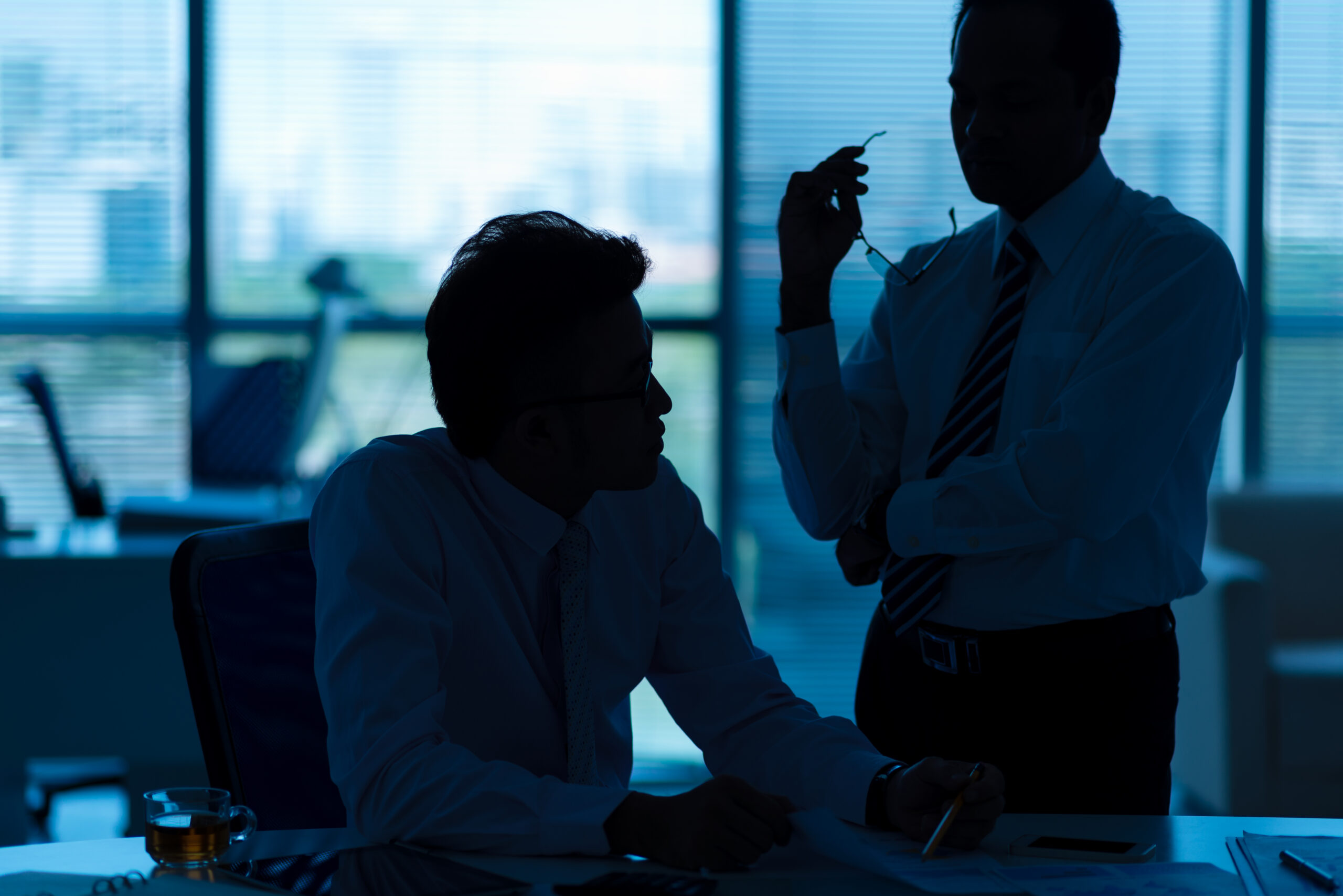 Businessmen discussing common mistakes to avoid in white-collar crime investigations.